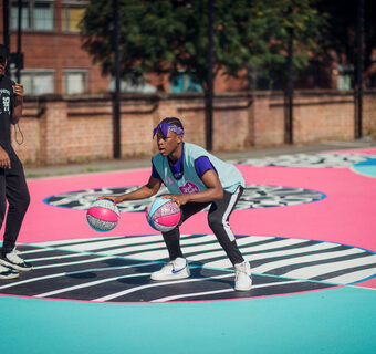 Shooting hoops at the Pink Lady® basketball court